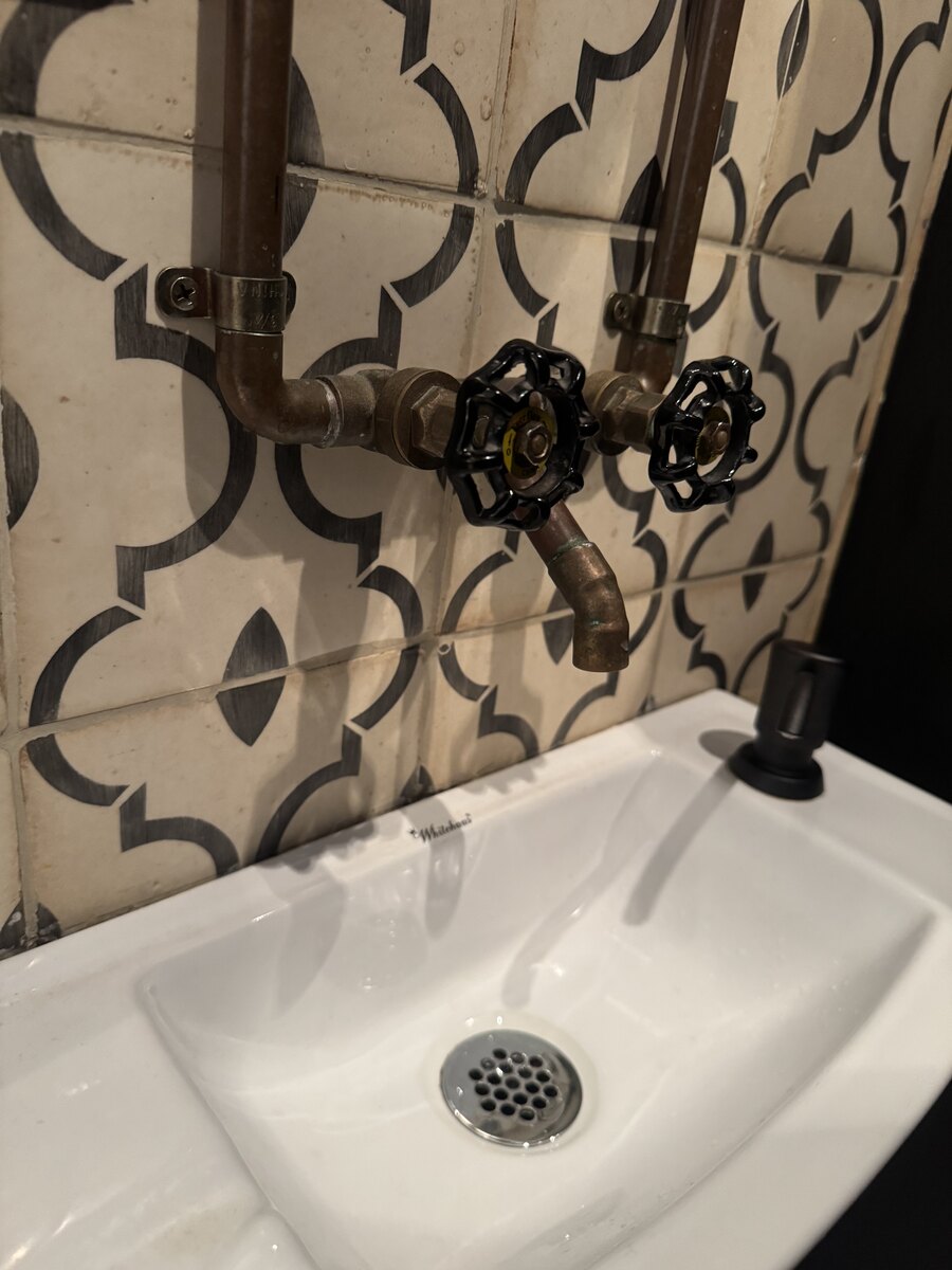 Wall-mounted faucets installed in a Brooklyn bathroom