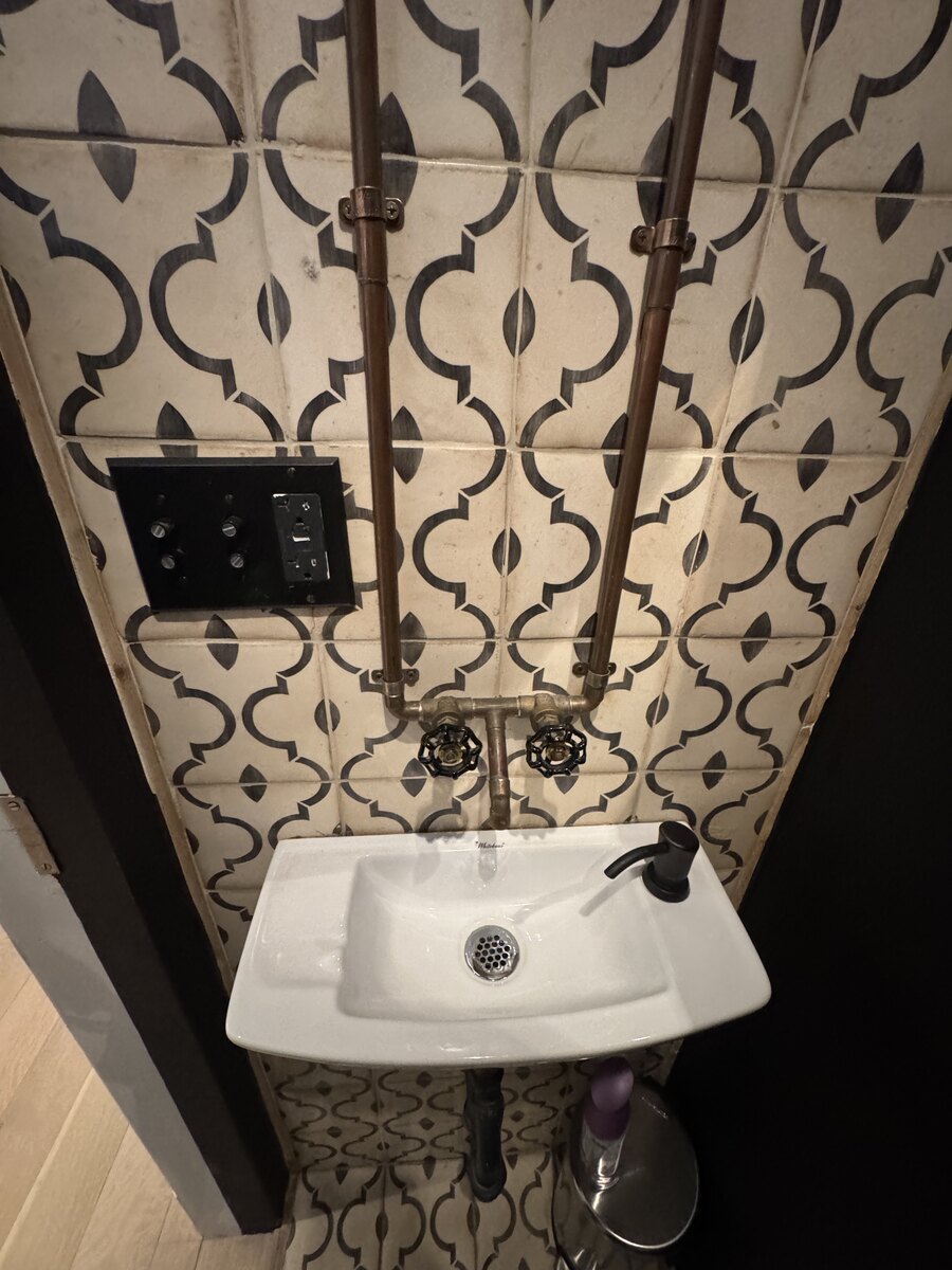 Wall-mounted bathroom faucets and compact sink installation